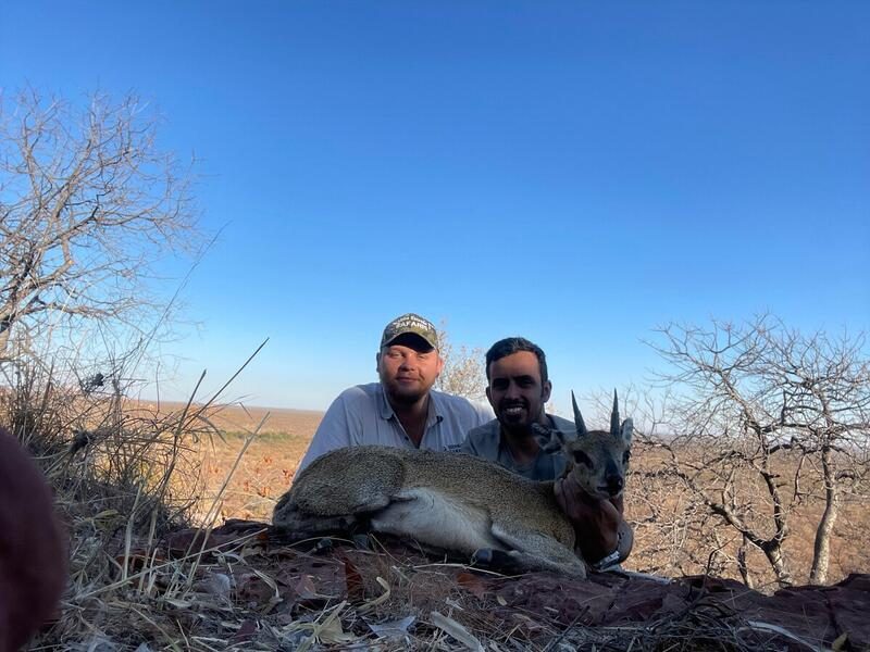 Guide and hunter in low sun
